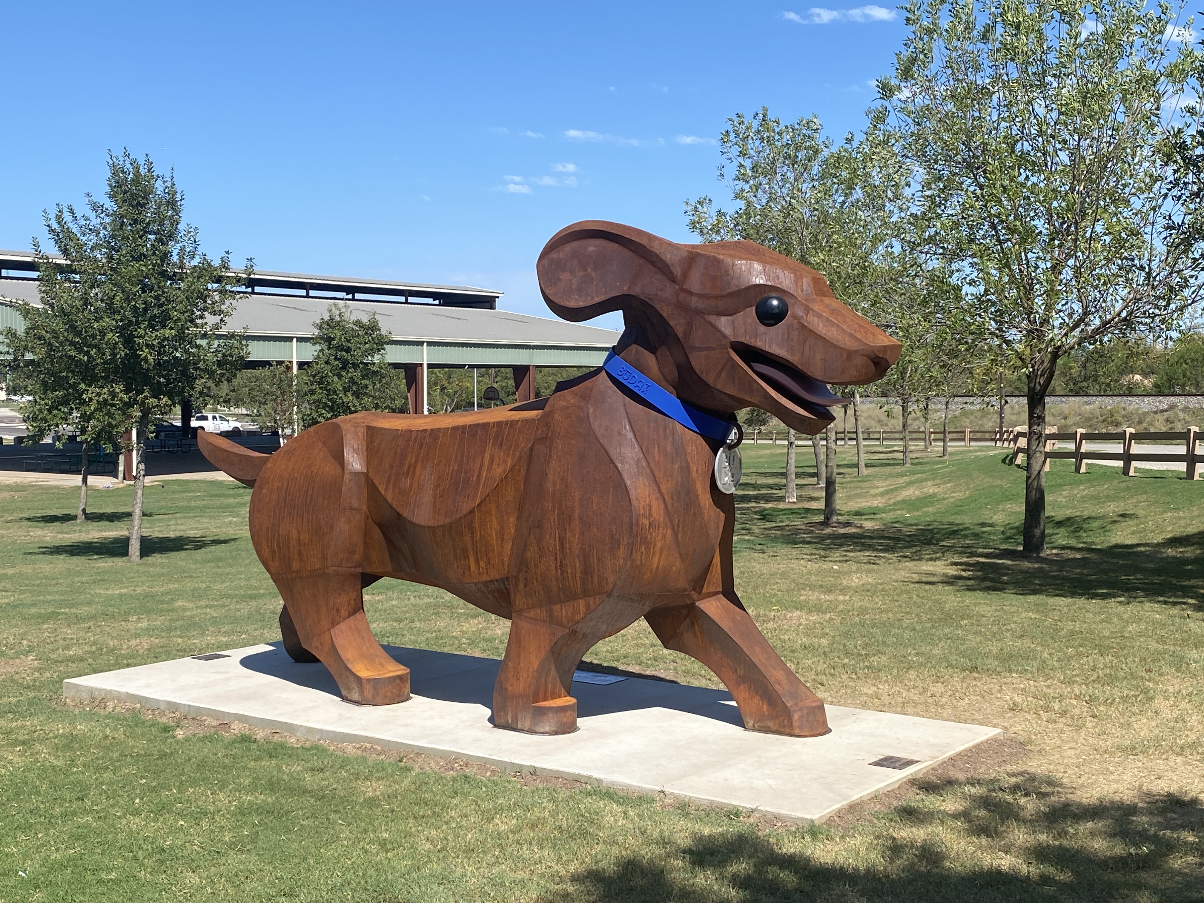 Large steel dachshund sculpture wearing a blue Buda collar at City Park.